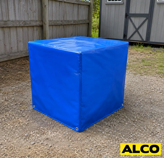 Heavy-duty waterproof storage cover protecting outdoor equipment or materials at an industrial facility.