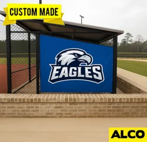 Custom-made dugout tarp protecting seating area from weather and debris by ALCO