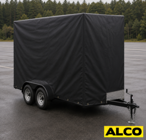 Heavy duty tarp cover with tie down straps fitted over a vending trailer for weather protection during transport or storage.
