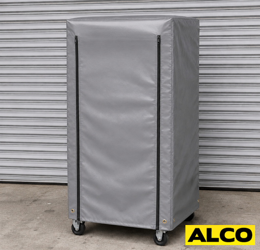 A heavy duty waterproof cover fitted over a roll cage in a warehouse storage setting.