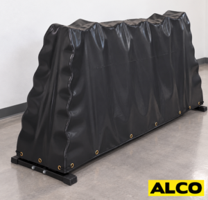Heavy-duty covers fitted over kettlebell stands in a gym or fitness facility storage area.