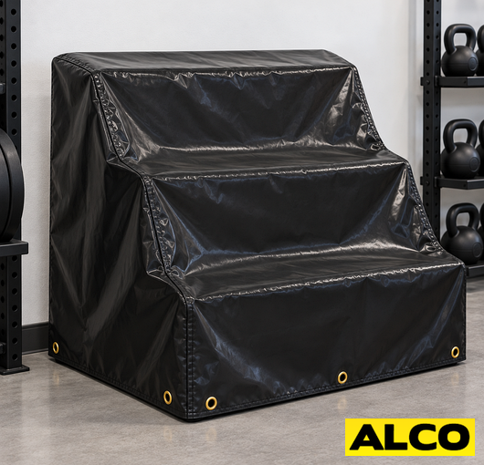 Heavy-duty covers fitted over outdoor kettlebell racks to protect gym equipment from weather exposure.