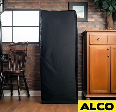 Black custom cover disguising a gun safe in a living room beside a wooden cabinet and chair