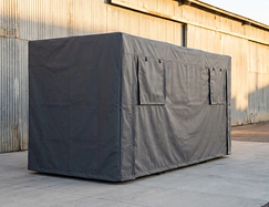 Custom-fabricated industrial equipment cover protecting heavy machinery in a warehouse or production facility.