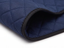 Quilted padded cover material swatch with black binding
